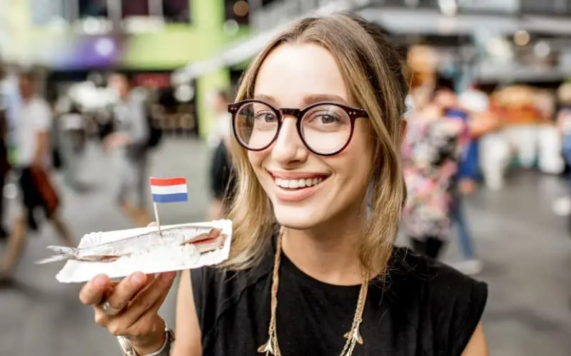Dutch girl eating some herring